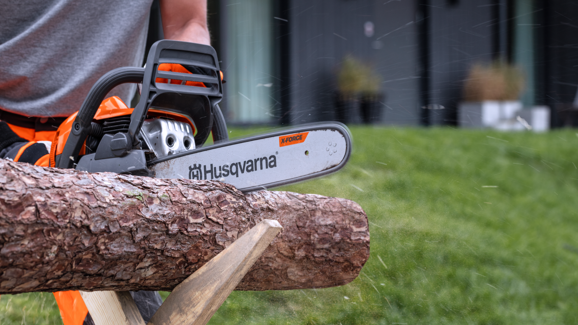 Chainsaw cutting through wood log